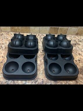 Four-hole silicone ice ball maker (2) trays with lids.